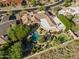 Aerial view of the property with a pool, patio, desert landscaping, and putting green at 13249 E Summit Dr, Scottsdale, AZ 85259