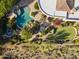 Aerial view of a luxurious backyard with pool, spa, putting green, and desert landscaping at 13249 E Summit Dr, Scottsdale, AZ 85259