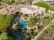 Bird's-eye view showcasing backyard with pool, spa, putting green, outdoor kitchen and beautiful desert landscaping at 13249 E Summit Dr, Scottsdale, AZ 85259