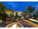 Backyard with comfortable lounge area, pool, lush landscaping, and a fire pit for evening relaxation at 13249 E Summit Dr, Scottsdale, AZ 85259