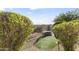 Private backyard featuring a built-in grill area, synthetic grass, and desert landscaping for outdoor enjoyment at 13249 E Summit Dr, Scottsdale, AZ 85259
