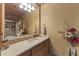 Bathroom featuring a beige marble countertop and decorative elements like flowers and stylish towels at 13249 E Summit Dr, Scottsdale, AZ 85259