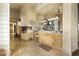 Spacious bathroom featuring dual vanities, granite countertops, and travertine flooring at 13249 E Summit Dr, Scottsdale, AZ 85259