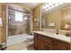 Well-lit bathroom featuring a tiled shower with glass door and a vanity with marble countertops at 13249 E Summit Dr, Scottsdale, AZ 85259
