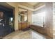 Luxurious bathroom with a soaking tub and natural light from the glass block window at 13249 E Summit Dr, Scottsdale, AZ 85259