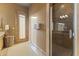 Elegant bathroom featuring a glass-enclosed shower, travertine tile, and natural light at 13249 E Summit Dr, Scottsdale, AZ 85259