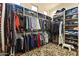 Walk-in closet featuring built-in shelving and ample storage, providing organized wardrobe space at 13249 E Summit Dr, Scottsdale, AZ 85259