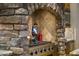 Gourmet kitchen includes a stainless cooktop with stone arch and decorative backsplash at 13249 E Summit Dr, Scottsdale, AZ 85259