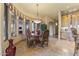 Elegant dining room with a glass table, ornate chairs, large windows, and custom millwork at 13249 E Summit Dr, Scottsdale, AZ 85259