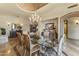 Elegant dining room featuring decorative ceiling, chandelier, and large glass table at 13249 E Summit Dr, Scottsdale, AZ 85259