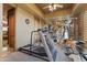Bright exercise room with modern equipment and mirrored wall for fitness enthusiasts at 13249 E Summit Dr, Scottsdale, AZ 85259