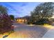 Beautiful single Gathering home with a three car garage, desert landscaping, and brick paved driveway at 13249 E Summit Dr, Scottsdale, AZ 85259