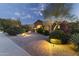 Inviting home exterior with brick driveway and vibrant landscaping under a beautiful evening sky at 13249 E Summit Dr, Scottsdale, AZ 85259