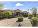 Expansive front view of this stunning residence displaying manicured landscaping and circular driveway at 13249 E Summit Dr, Scottsdale, AZ 85259