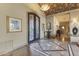 Grand foyer boasts stone floors, wrought iron doors, decorative ceiling, and elegant decor at 13249 E Summit Dr, Scottsdale, AZ 85259