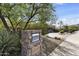 Landscaped front yard view of home with desert plants, stone mailbox, and circular driveway at 13249 E Summit Dr, Scottsdale, AZ 85259