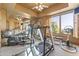 Well-equipped home gym featuring various exercise machines and a mirrored wall to enhance workout space at 13249 E Summit Dr, Scottsdale, AZ 85259