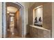 Hallway with beautiful tile work and stone archway leading to a storage area at 13249 E Summit Dr, Scottsdale, AZ 85259