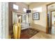 Hallway with unique decor featuring accent seating, large mirror, light fixtures, and tile flooring at 13249 E Summit Dr, Scottsdale, AZ 85259
