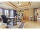 Elegant home office featuring custom millwork, a decorative ceiling, and a beautiful executive desk setup at 13249 E Summit Dr, Scottsdale, AZ 85259