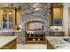 Gourmet kitchen boasts custom cabinets, stone accents, granite countertops, and stainless steel appliances at 13249 E Summit Dr, Scottsdale, AZ 85259