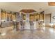 Open kitchen with a large island, stone accents, and custom cabinetry at 13249 E Summit Dr, Scottsdale, AZ 85259