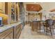 Gourmet kitchen with custom wood cabinets, granite counters and large island with seating provides ample prep space at 13249 E Summit Dr, Scottsdale, AZ 85259