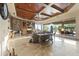 Expansive living room featuring a stone fireplace, built-in shelving, and walls of glass leading to the outside at 13249 E Summit Dr, Scottsdale, AZ 85259