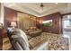 Recreation room with a large leather sectional, TV, and exercise equipment at 13249 E Summit Dr, Scottsdale, AZ 85259