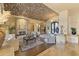 Elegant living room featuring a brick barrel ceiling and a cozy stone fireplace at 13249 E Summit Dr, Scottsdale, AZ 85259