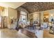 Spacious living room with a barrel brick ceiling, large windows, and a stone fireplace at 13249 E Summit Dr, Scottsdale, AZ 85259