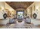Spacious living room with vaulted brick ceiling, fireplace, and backyard views creating a cozy ambiance at 13249 E Summit Dr, Scottsdale, AZ 85259