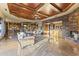 Open concept living area featuring stone accent walls, high ceilings, marble floors and a wet bar for entertaining at 13249 E Summit Dr, Scottsdale, AZ 85259