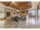 Expansive living room featuring a stone accent wall, custom ceiling design, and marble floors at 13249 E Summit Dr, Scottsdale, AZ 85259