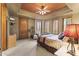 Spacious main bedroom with bay window, custom shutters, and a ceiling fan at 13249 E Summit Dr, Scottsdale, AZ 85259