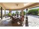 Covered patio with outdoor dining area and views of the backyard pool and desert landscape at 13249 E Summit Dr, Scottsdale, AZ 85259