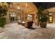 Beautiful covered outdoor patio with a gas fireplace, comfortable seating, and ceiling fan for relaxing at 13249 E Summit Dr, Scottsdale, AZ 85259