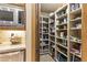 Well-stocked pantry with ample shelving and storage space next to the kitchen counter with appliances at 13249 E Summit Dr, Scottsdale, AZ 85259