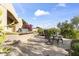 Outdoor patio with grill, seating area, lush desert landscaping and mountain views at 13249 E Summit Dr, Scottsdale, AZ 85259
