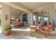 Covered patio featuring comfortable seating and views of the surrounding landscape through large windows at 13249 E Summit Dr, Scottsdale, AZ 85259