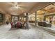 Inviting outdoor patio with comfortable seating, a ceiling fan, a tv, and views of the home's interior at 13249 E Summit Dr, Scottsdale, AZ 85259