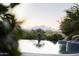 Picturesque mountain views from the edge of an infinity pool, blending nature with luxurious living at 13249 E Summit Dr, Scottsdale, AZ 85259