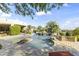 Resort style backyard pool and spa features a rock waterfall and tropical landscaping at 13249 E Summit Dr, Scottsdale, AZ 85259