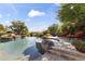 Backyard pool with beautiful rock waterfall, spa, lounge chairs, desert landscaping, and mountain views at 13249 E Summit Dr, Scottsdale, AZ 85259