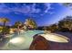 Backyard pool with a rock waterfall, a spa, desert landscaping, and beautiful night sky at 13249 E Summit Dr, Scottsdale, AZ 85259