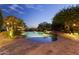 Backyard pool with mature landscaping, rock features and spa offers an oasis with views of the surrounding area at 13249 E Summit Dr, Scottsdale, AZ 85259