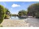 Resort-style pool area with lush greenery, rock features, and stunning mountain views creates a private oasis at 13249 E Summit Dr, Scottsdale, AZ 85259