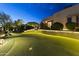 Nighttime view of the private putting green with landscape lighting, creating an inviting outdoor entertainment space at 13249 E Summit Dr, Scottsdale, AZ 85259
