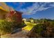 Beautifully landscaped putting green area at twilight with brick paving and lush desert vegetation at 13249 E Summit Dr, Scottsdale, AZ 85259