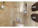 Close-up of the shower features stone tile walls, rainfall showerhead, and built-in niche for toiletries at 13249 E Summit Dr, Scottsdale, AZ 85259